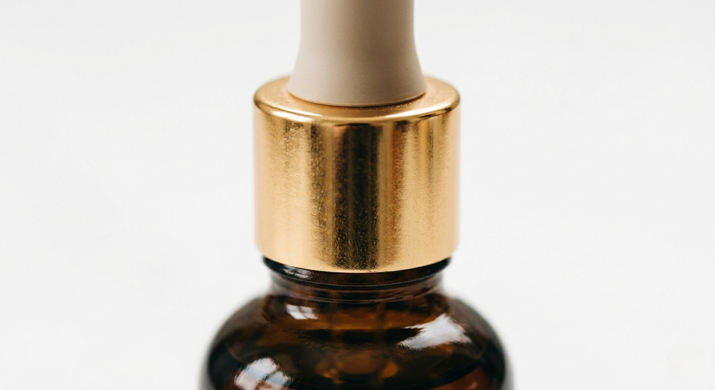 Product detail photography — gold dropper close-up